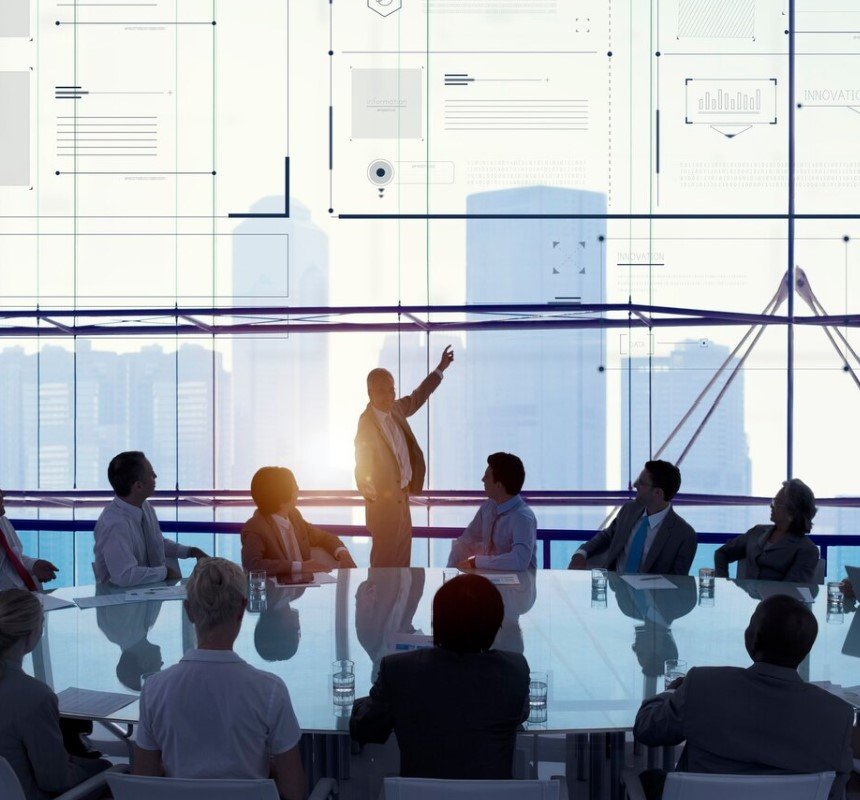 Training session in a modern room with several people, and a transparent window displaying a city skyline and digital information, symbolizing modern training.